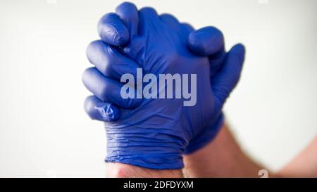 The medical worker gathered his hands in fists.On white background.Language of the body. Stock Photo