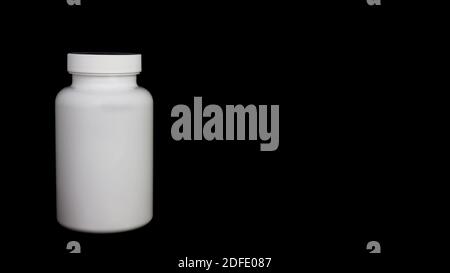 Empty white medical bottle on a black background Stock Photo