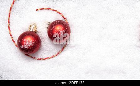 Red Christmas balls, Christmas tree decorations on snow, layout, space for text Stock Photo