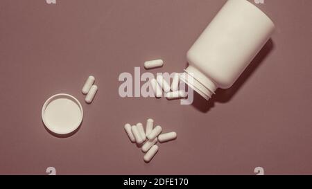 Pills, vitamins,drugs scattered with plastic jars,top view. Stock Photo