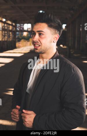 Young caucasian man posing in a abandoned pavilion. Stock Photo