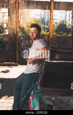 Young caucasian man posing in a abandoned pavilion. Stock Photo