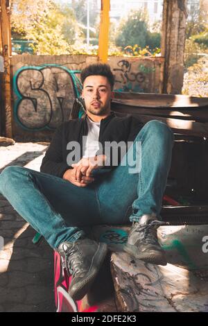 Young caucasian man posing in a abandoned pavilion. Stock Photo