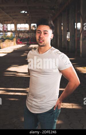 Young caucasian man posing in a abandoned pavilion. Stock Photo