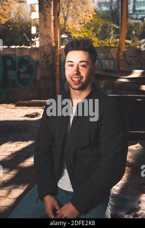 Young caucasian man posing in a abandoned pavilion. Stock Photo