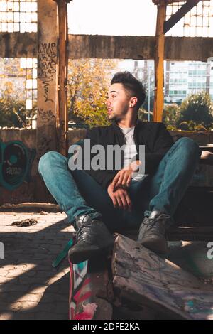 Young caucasian man posing in a abandoned pavilion. Stock Photo