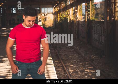 Young caucasian man posing in a abandoned pavilion. Stock Photo