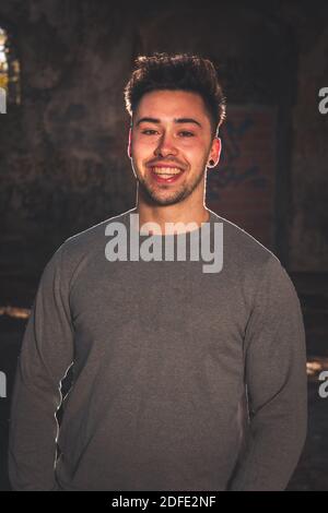 Young caucasian man posing in a abandoned pavilion. Stock Photo
