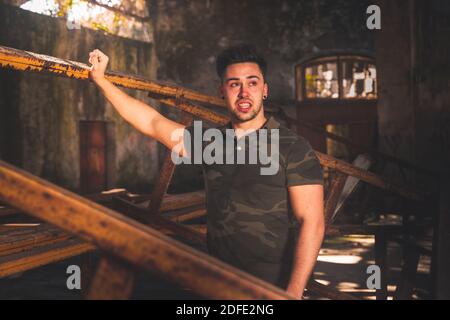 Young caucasian man posing in a abandoned pavilion. Stock Photo