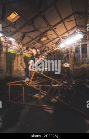 Young caucasian man posing in a abandoned pavilion. Stock Photo
