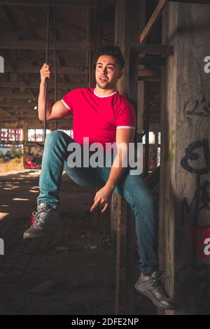 Young caucasian man posing in a abandoned pavilion. Stock Photo