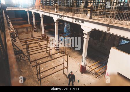 Young man exploring an abandoned industrial building. Stock Photo