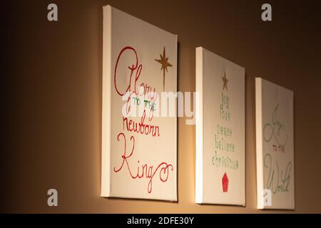 Word art paintings for Christmas hanging on wall with morning light, copy space, Christmas holiday background Stock Photo