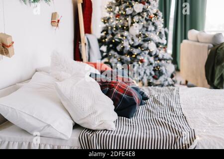 Cozy bed with Christmas pillows decorated with Christmas decor Stock Photo  - Alamy