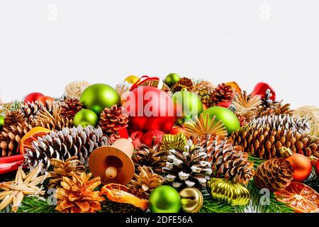 Traditional Christmas ornaments, fir branches and pine cones. Christmas decoration with baubles and dried orange slices. Christmas greeting background Stock Photo