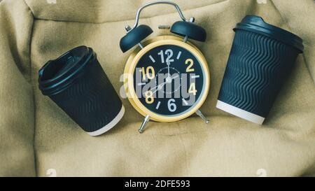 Retro clock top view,coffee in a plastic cup,aromatic coffee in cups. Stock Photo