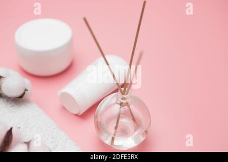 spa concept, cotton white jars on a pink background, copy space, top view Stock Photo