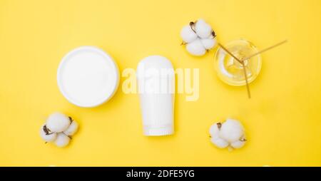 personal hygiene product white jars on a yellow background, copy space, top view Stock Photo