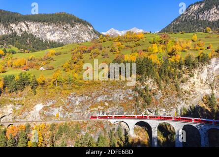 Filisur, Switzerland - October 26, 2019: A red train is crossing the famous Landwasser Viaduct - a unesco heritage Stock Photo