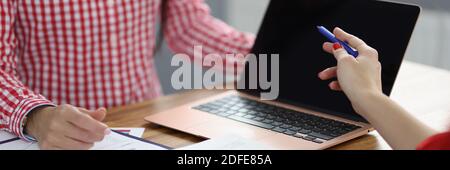 Partners at working table discuss business processes. Stock Photo