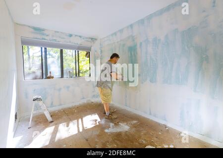 Work hand tool wall using plastering tool for unfinishing wall Stock Photo