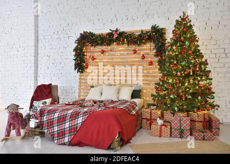 Christmas bedroom interior on a brick wall background Stock Photo