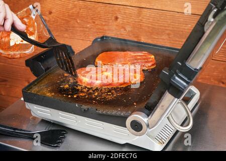 Two pork steak cutlets grilled on electric grill Stock Photo