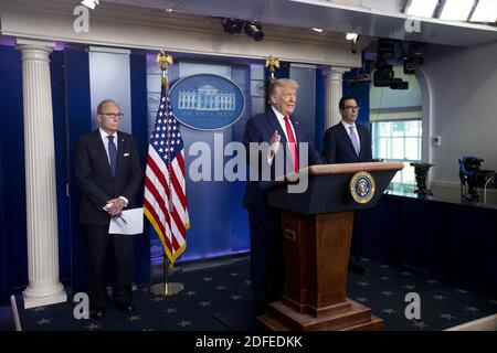 US President Donald J. Trump (C) participates in a news conference on jobs figures, beside Director of the US National Economic Council Larry Kudlow (L) and US Treasury Secretary Steven Mnuchin (R) in the James Brady Press Briefing Room of the White House in Washington, DC, USA, 02 July 2020. The US added 4.8 million jobs in June as the economy tried to recover during the coronavirus COVID-19 pandemic. Photo by MICHAEL REYNOLDS/Pool/ABACAPRESS.COM Stock Photo