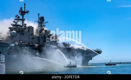 Hand out photo of Port of San Diego Harbor Police Department boats combat a fire on board USS Bonhomme Richard (LHD 6) at Naval Base San Diego, CA, USA, July 12, 2020. On the morning of July 12, a fire was called away aboard the ship while it was moored pier side at Naval Base San Diego. Local, base and shipboard firefighters responded to the fire. USS Bonhomme Richard is going through a maintenance availability, which began in 2018. U.S. Navy photo by Mass Communication Specialist 3rd Class Christina Ross via ABACAPRESS.COM Stock Photo