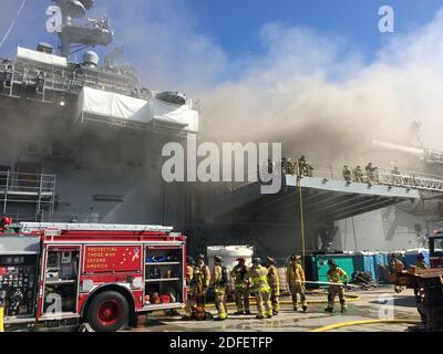 Hand out photo of sailors and Federal Fire San Diego firefighters combat a fire aboard USS Bonhomme Richard (LHD 6) July 12. On the morning of July 12, 2020, a fire was called away aboard the ship while it was moored pierside at Naval Base San Diego, CA, USA. Local, base and shipboard firefighters responded to the fire. USS Bonhomme Richard is going through a maintenance availability, which began in 2018. U.S. Navy photo by Mass Communication Specialist 1st Class Jason Kofonow via ABACAPRESS.COM Stock Photo