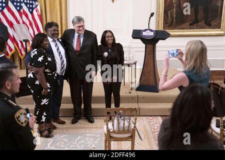 United States Attorney General William P. Barr poses for a photo in the East Room with the family of LeGend Taliferro following remarks from U.S. President Donald Trump on 'Operation Legend: Combatting Violent Crime in American Cities' at the White House in Washington, DC, USA, on Wednesday, July 22, 2020. Taliferro was killed by gun violence in Kansas City, Missouri. Photo by Sarah Silbiger/Pool/ABACAPRESS.COM Stock Photo