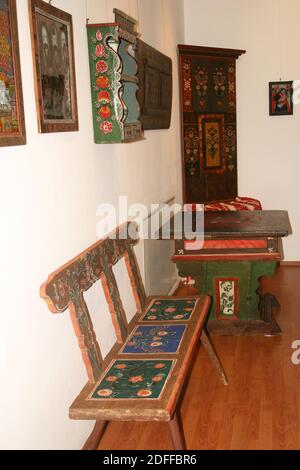 Hand-painted decoration on double doors in traditional with rush-seated  ladder-back chair and terracotta tiled floor Stock Photo - Alamy