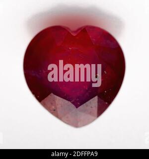 Natural ruby in the shape of a heart on a white background Stock Photo