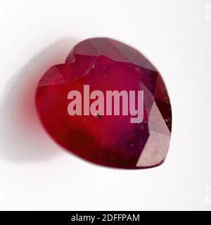 Natural ruby in the shape of a heart on a white background Stock Photo