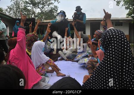 A woman volunteers seen gave point of minds for the childrens which affected by the Sinabung volcano eruption during received the aid from Al Kahfi Foundation volunteers as an charitable aid action for residents of the villages of Kuta Tengah, Berastepu and Gamber (Tiga Serangkai) at the Al-Jihad mosque in Karo, North Sumatra, Indonesia on August 30, 2020. In several news related to the eruption of the Sinabung volcano, humanely some volunteers of Al-Kahfi came to treated psychology of residents, especially for childrens who live on the threshold of a geological disaster hazard zone. Photo by Stock Photo