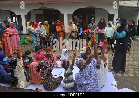 A woman volunteers seen gave point of minds for the childrens which affected by the Sinabung volcano eruption during received the aid from Al Kahfi Foundation volunteers as an charitable aid action for residents of the villages of Kuta Tengah, Berastepu and Gamber (Tiga Serangkai) at the Al-Jihad mosque in Karo, North Sumatra, Indonesia on August 30, 2020. In several news related to the eruption of the Sinabung volcano, humanely some volunteers of Al-Kahfi came to treated psychology of residents, especially for childrens who live on the threshold of a geological disaster hazard zone. Photo by Stock Photo