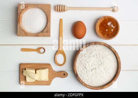 Step-by-step heart-shaped cake recipe instructions. Bakery ingredients. Butter flour sugar egg honey soda salt. Flat lay. Stock Photo