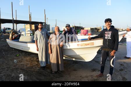 Omani fishermen by their fishing boat in Barka, Oman. Stock Photo