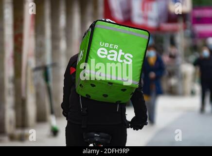 Bucharest, Romania - November 12, 2020: An Uber Eats food delivery courier delivers food in Bucharest, Romania. Stock Photo