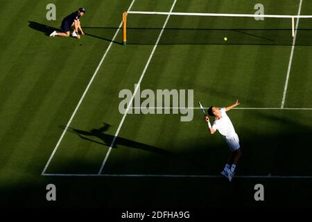 Tim Henman of Great Britain serving to Carlos Moya of Spain during their 2nd round match on Center Court at Wimbledon in 2007. Stock Photo