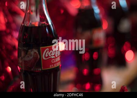 Augusta, Ga USA - 12 04 20: Coca Cola Vintage 1997 Bottle and red bokeh Stock Photo