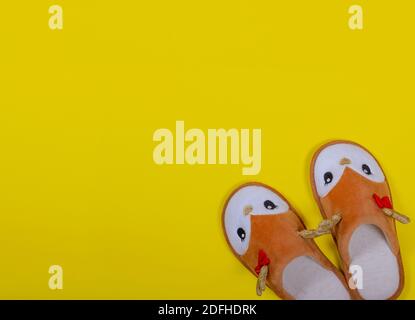 Home slippers in the form of a Christmas deer on a yellow background. Christmas and New Year concept. Stay at home. Postcard. Copy space. Flat lay Stock Photo