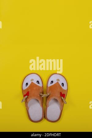 Home slippers in the form of a Christmas deer on a yellow background. Christmas and New Year concept. Stay at home. Postcard. Copy space. Flat lay Stock Photo
