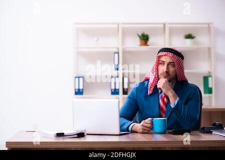 Young male arab employee working in the office Stock Photo