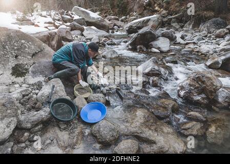 Outdoor adventures on river. Gold panning, searching for gold Stock Photo