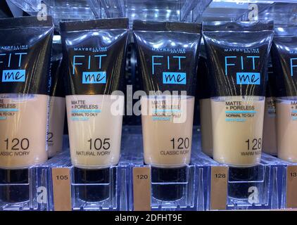 Viersen, Germany - May 9. 2020: Closeup of tubes Maybelline fit me makeup in shelf of german supermarket