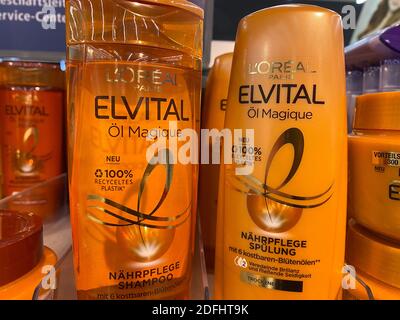 Viersen, Germany - May 9. 2020: Closeup of bottles loreal Elvital shampoo in shelf of german supermarket