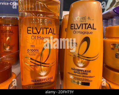 Viersen, Germany - May 9. 2020: Closeup of bottles loreal Elvital shampoo in shelf of german supermarket