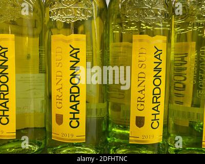 Viersen, Germany - May 9. 2020: Close up of bottles Chardonnay wine in shelf of german supermarket