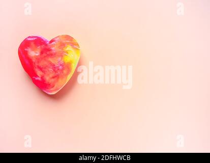 Colorful soap in the heart shape on soft background. Stock Photo